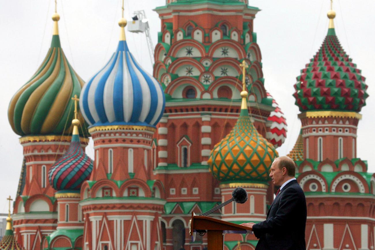 The photo shows Putin in profile in front of St.Basil's Cathedral in Red speaking at a podium. 