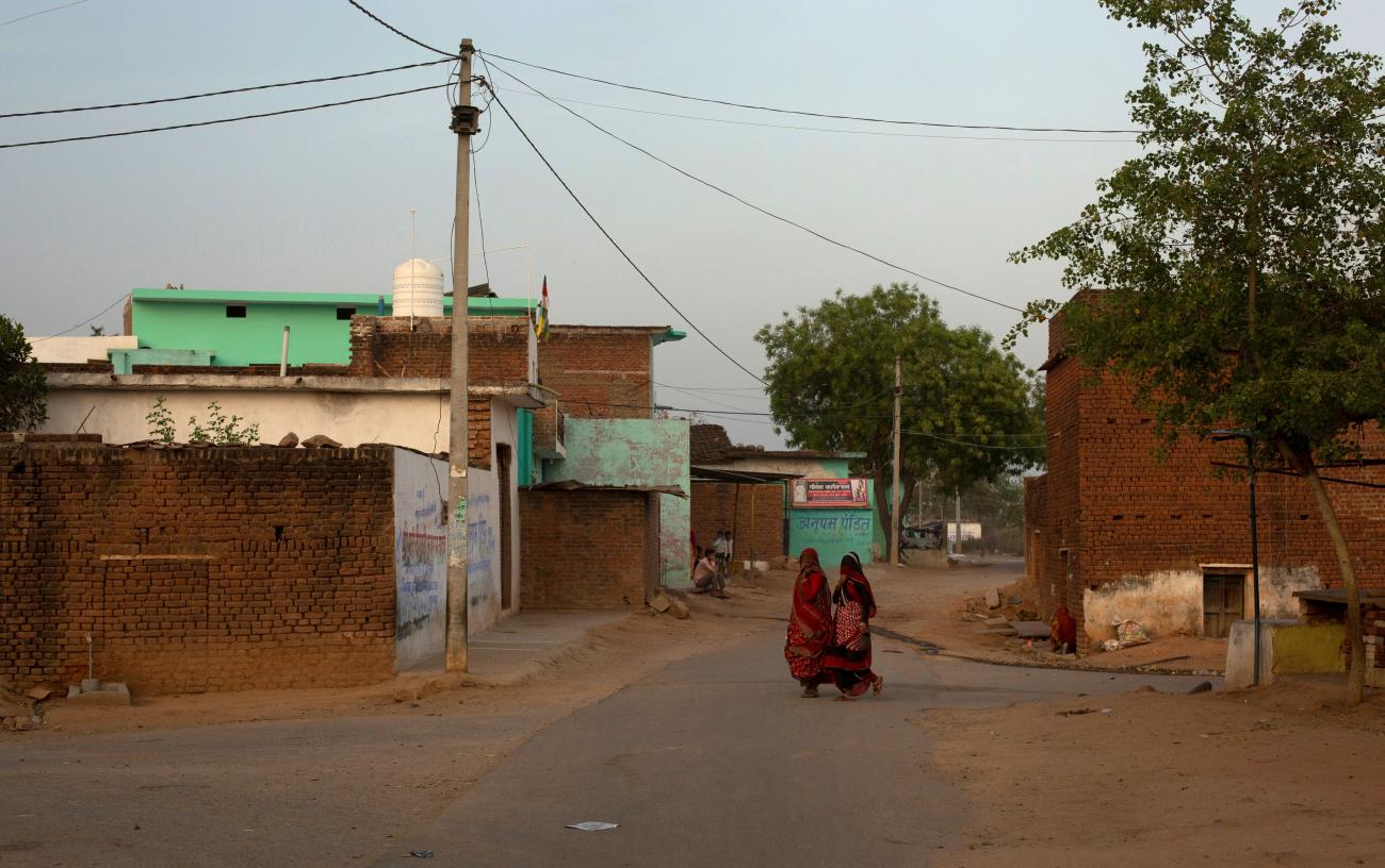 DOCUMENT DATE: April 21, 2020 Women walk through an empty street during nationwide lockdown in India to slow the spread of the coronavirus, in Jugyai village in the central state of Madhya Pradesh, India, April 8, 2020. 