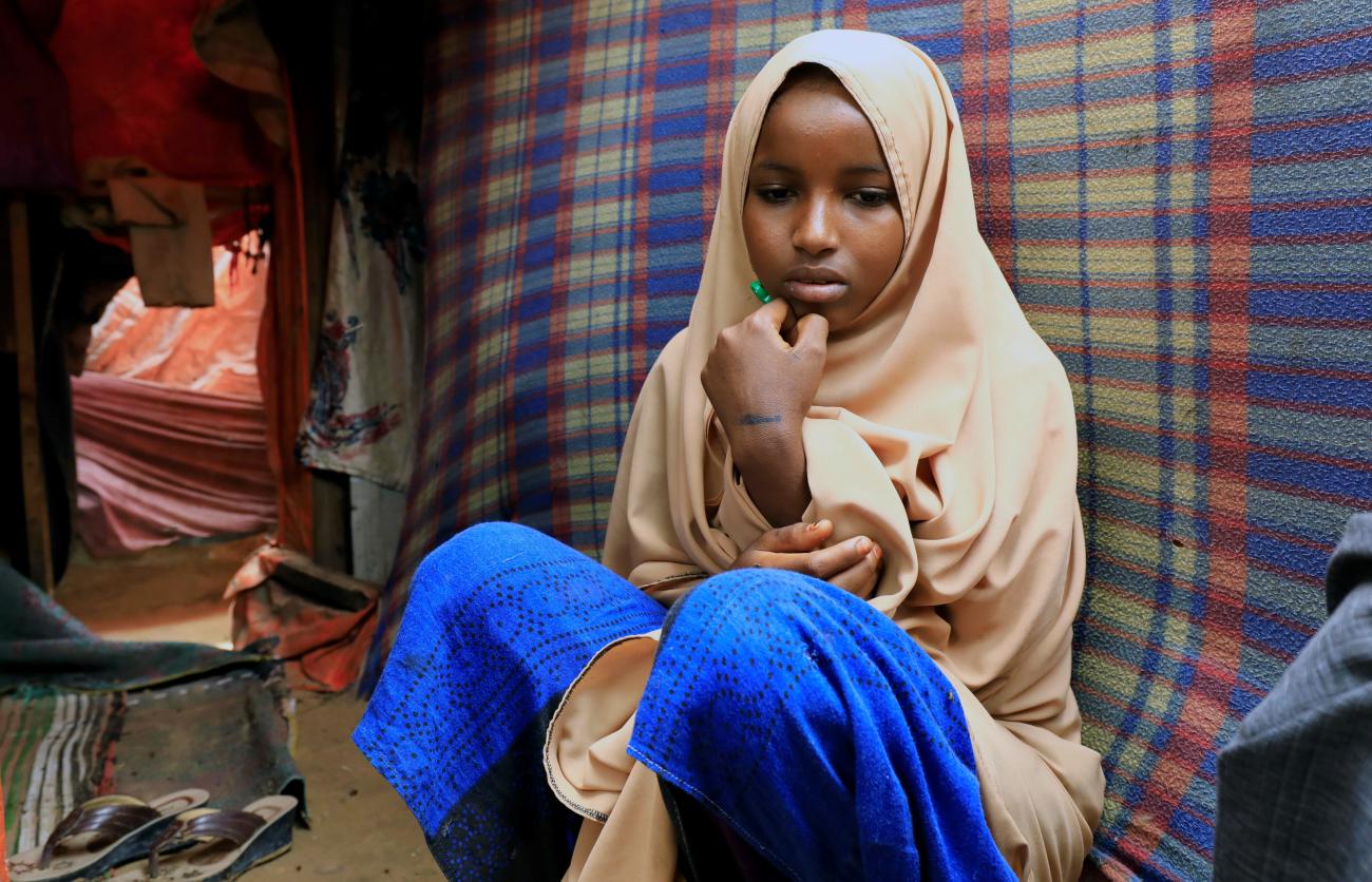 A Somali girl sits inside her mother's makeshift shelter after she ran away from a suspected forced marriage at the Alafuuto camp for internally displaced persons in Garasbaaley district of Mogadishu, Somalia on August 14, 2020.
