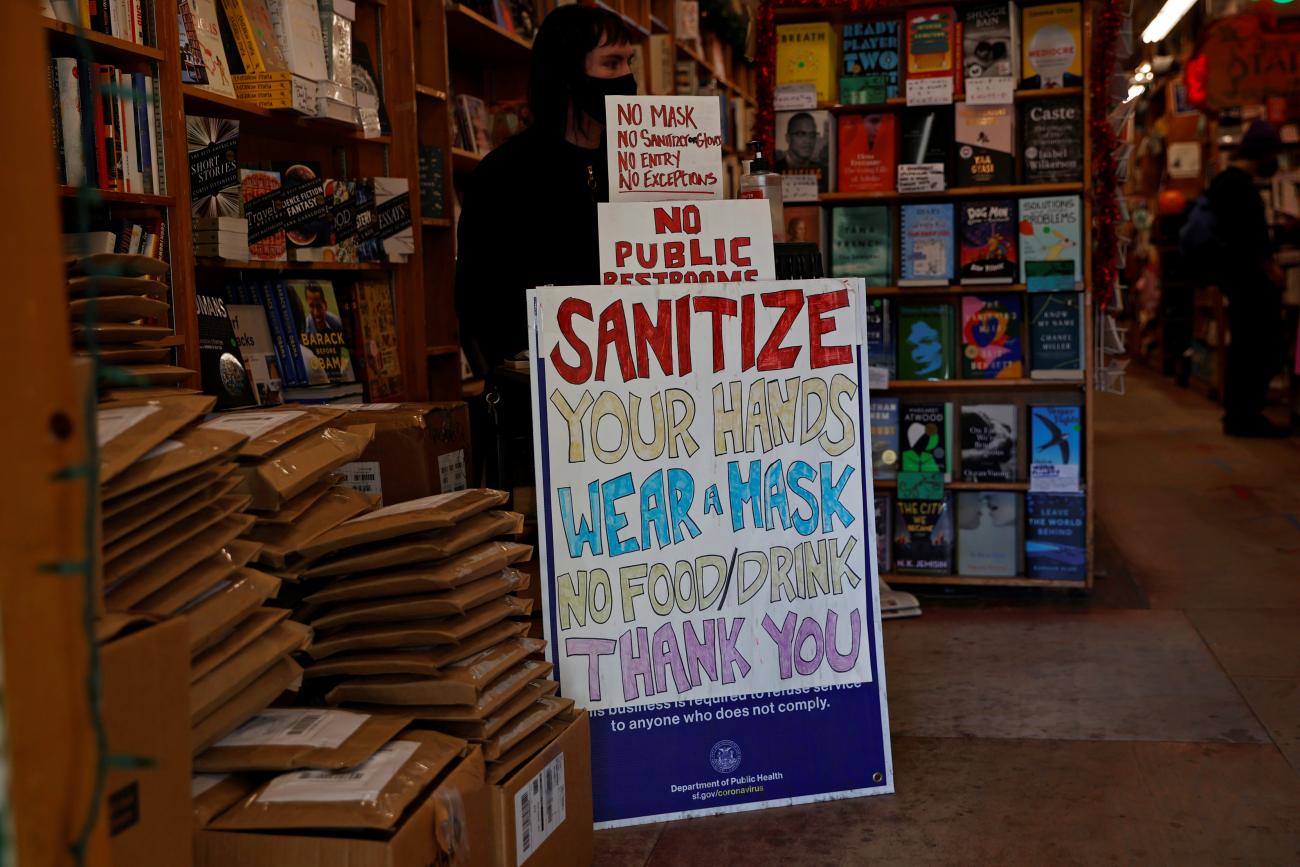 A safety protocol sign is seen at the entrance of a store ahead of the new stay-at-home order in attempts to stem coronavirus spikes in San Francisco, California on December 6, 2020.