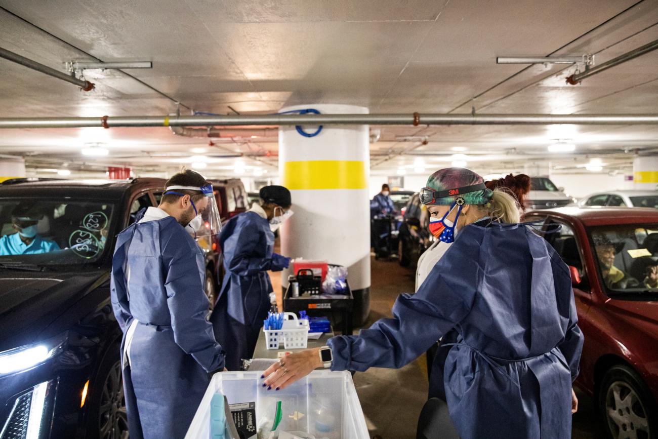Nurses prepare for the next round of people waiting in their vehicles to receive the coronavirus disease vaccine at a drive through vaccination site in Detroit, Michigan on January 15, 2021