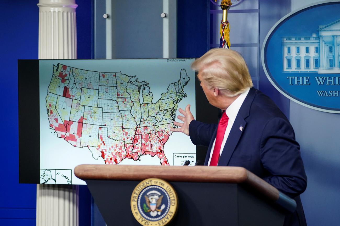 U.S. President Donald Trump points to a U.S. map of reported coronavirus cases as he speaks about reopening schools during a coronavirus disease (COVID-19) news briefing at the White House in Washington, U.S., July 23, 2020