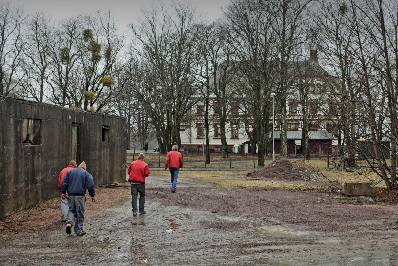 Inmates walk away from the shops where the work as they finish their working duties in Bastoy Prison on April 12, 2011 in Bastoy Island, Norway.