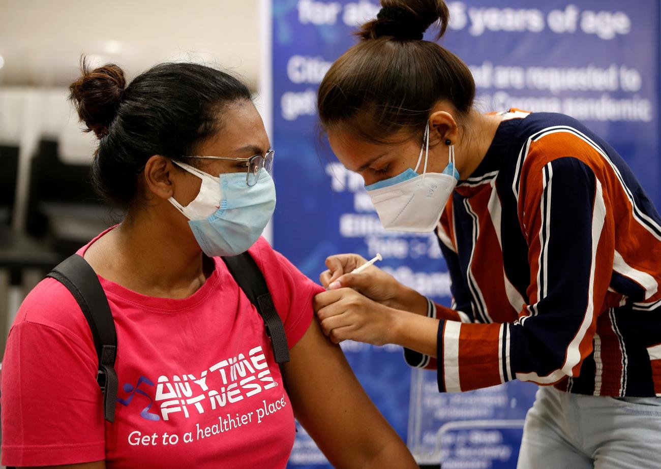 A woman receives a dose of COVISHIELD, a COVID-19 vaccine manufactured by Serum Institute of India, at a vaccination center in Ahmedabad, India on May 1, 2021.