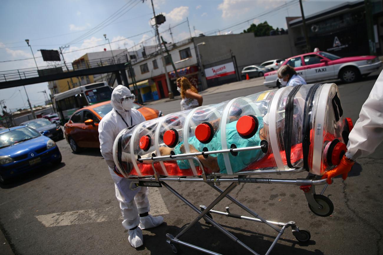 A patient suffering from the coronavirus disease (COVID-19) and diabetes, is pictured inside a capsule as Red Cross paramedics transfer him from a hospital to another in Mexico City, Mexico, June 8, 2020.