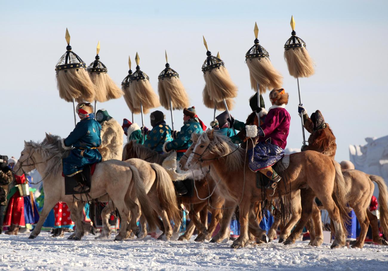 Participants in traditional Mongolian costumes ride horses at the opening ceremony of a winter Naadam fair in Hulunbuir, Inner Mongolia, China, on December 23, 2018.