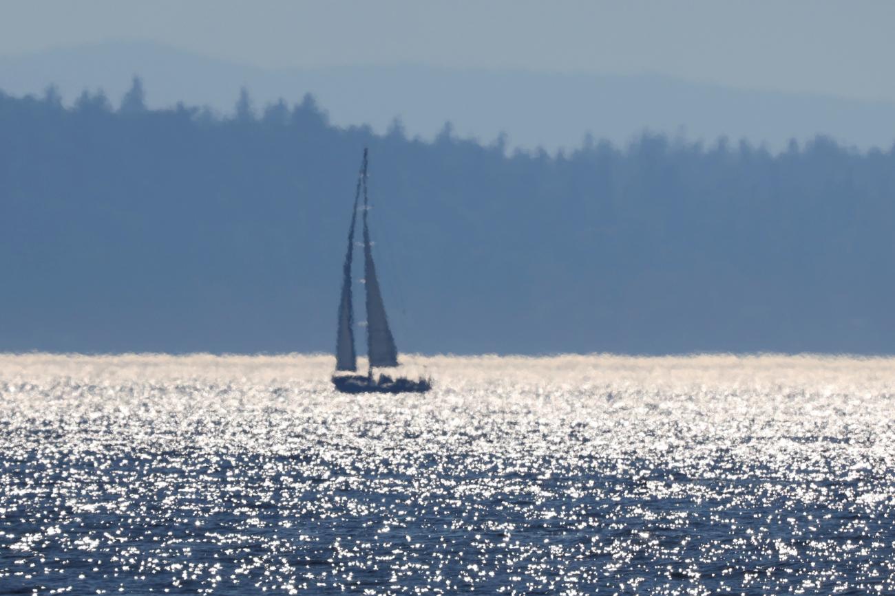 A sailboat is seen off Alki Beach during a heat wave in Seattle, Washington, on June 27, 2021. 