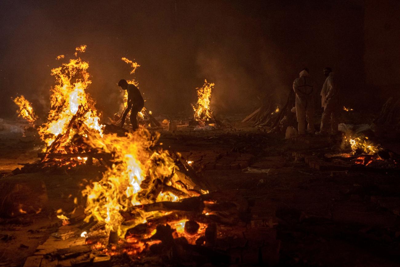 Flames are seen as the bodies of victims of COVID-19 are cremated in New Delhi, India, on April 24, 2021. 