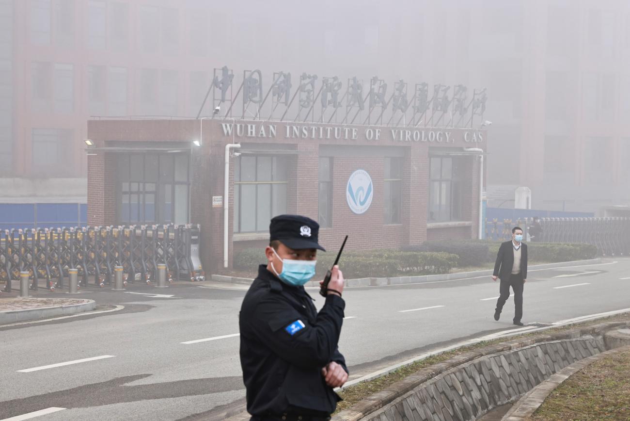 Security personnel stand outside Wuhan Institute of Virology as members of the World Health Organization (WHO) team tasked with investigating the origins of the coronavirus disease (COVID-19) arrive for a visit, in Wuhan, Hubei province, China February 3, 2021.