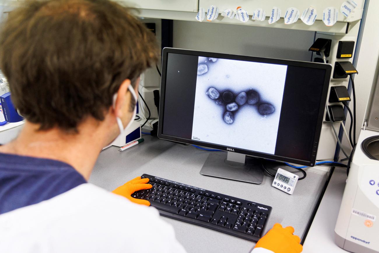 An employee at Bavarian Nordic views an image of a monkeypox virus in a lab, in Martinsried, Germany, on May 24, 2022. The company’s smallpox vaccine, Jynneos in the U.S. and Imvanex in Europe, is effective against monkeypox
