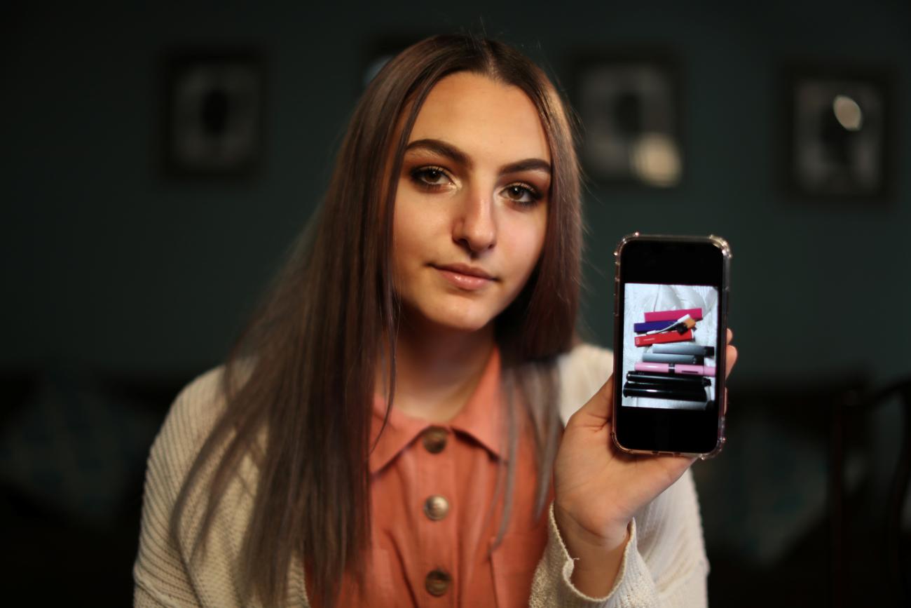 Simah Herman, 18, poses with a photo of her former vaping devices in her North Hollywood home, Los Angeles, California, on September 19, 2019.