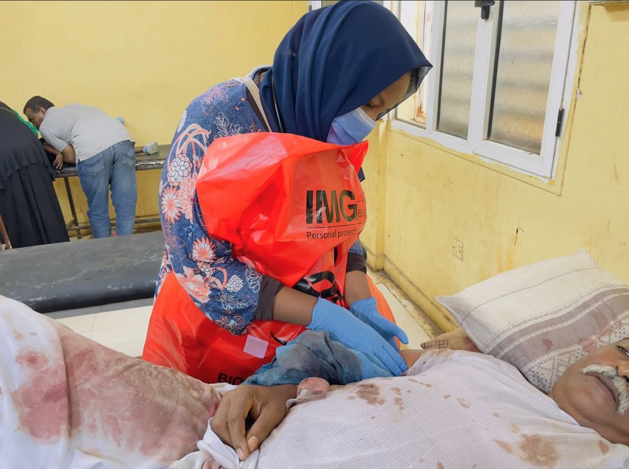 Hadeel Abdleseid, MBBS, Director of Sudan ECHO Center of Excellence, wearing a garbage bag for protection while rescuing a gunshot patient in Sudan, August 5, 2023. 