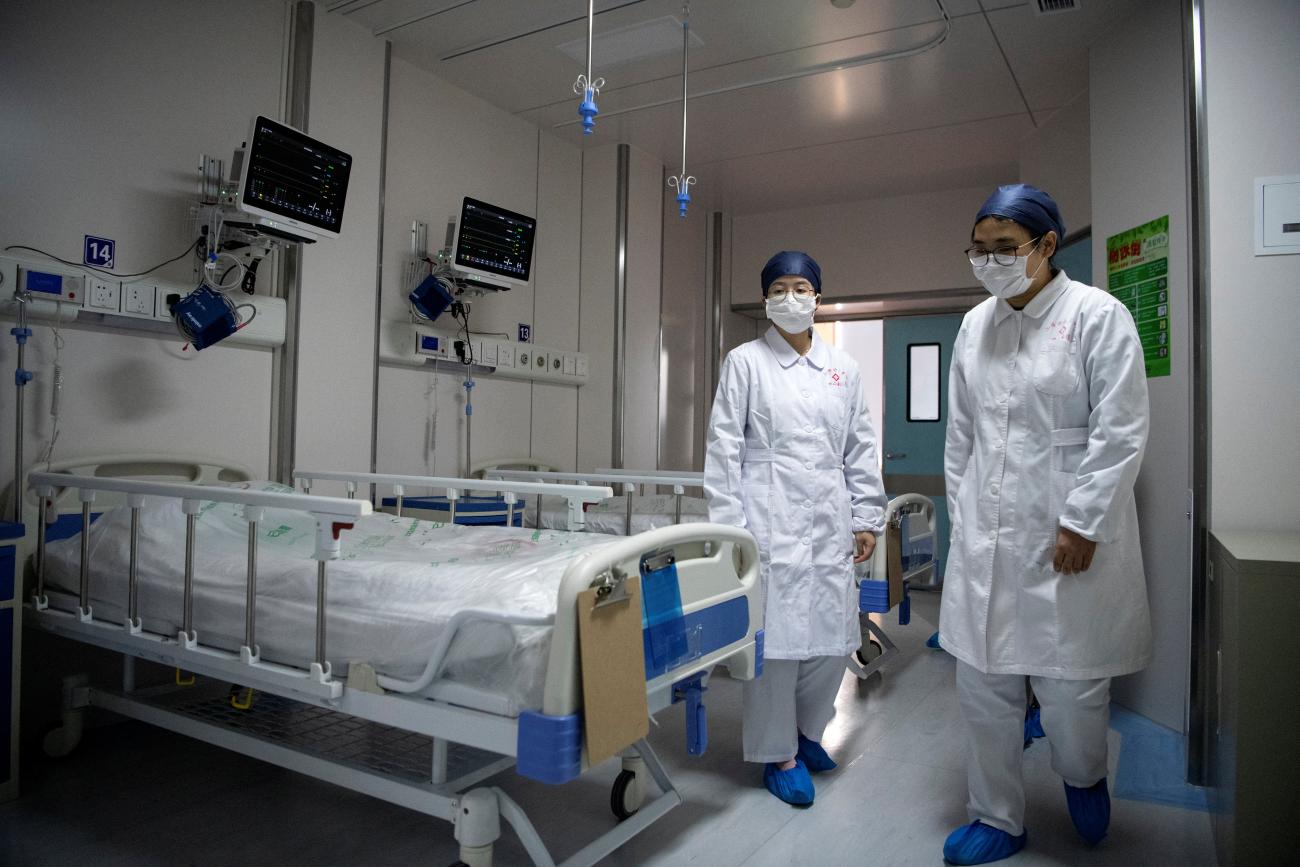 Nurses walk inside a quarantine room for COVID-19 patients at the Shanghai Public Health Clinical Center