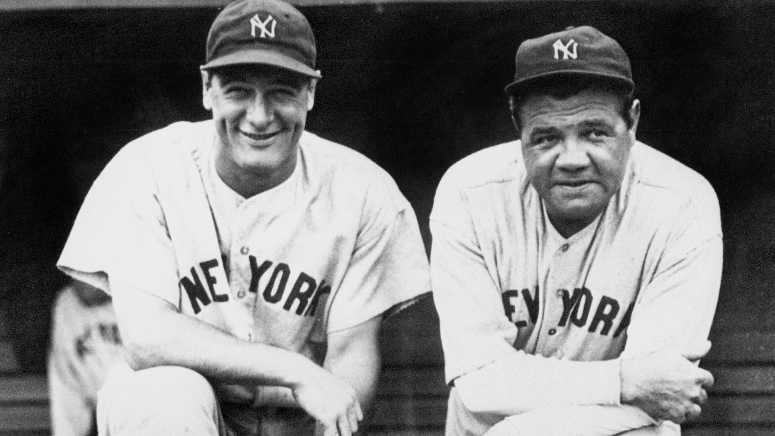 The photo shows Lou Gherig smiling while leaning on one knee propped on a dugout bench next to Babe Ruth.