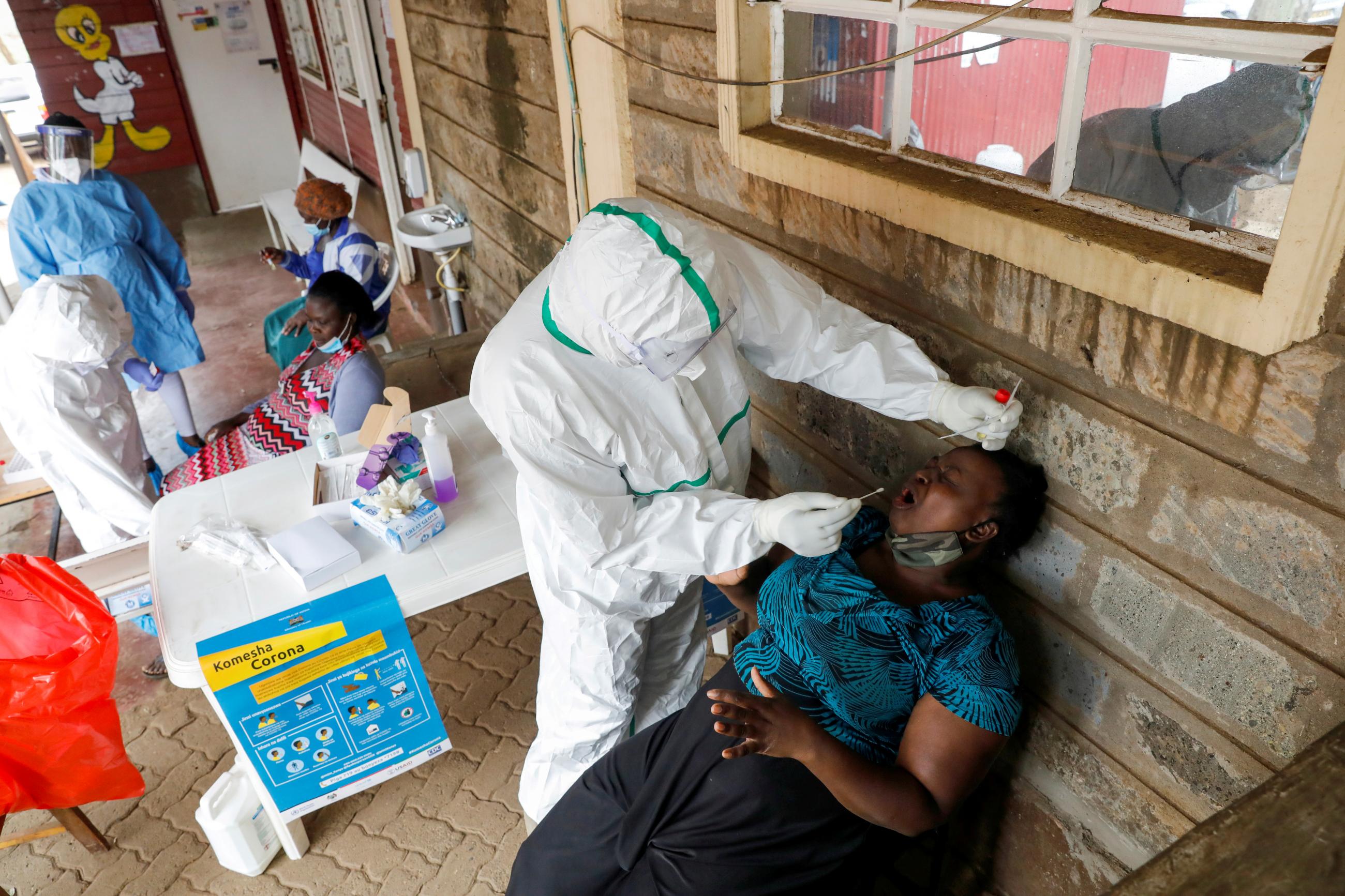 Health workers collect swab samples during free mass testing for the coronavirus disease (COVID-19) in Kibera slums of Nairobi, Kenya, on October 17, 2020. 