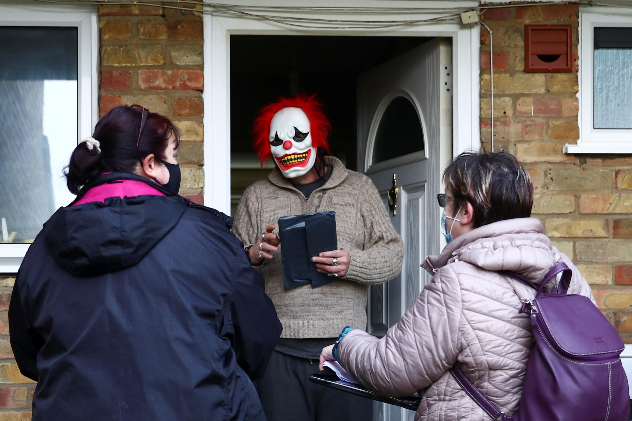 Volunteers hand out the COVID-19 home test kits to residents, in Goldsworth and St Johns, amid the outbreak of coronavirus disease (COVID-19) in Woking, Britain, February 2, 2021.