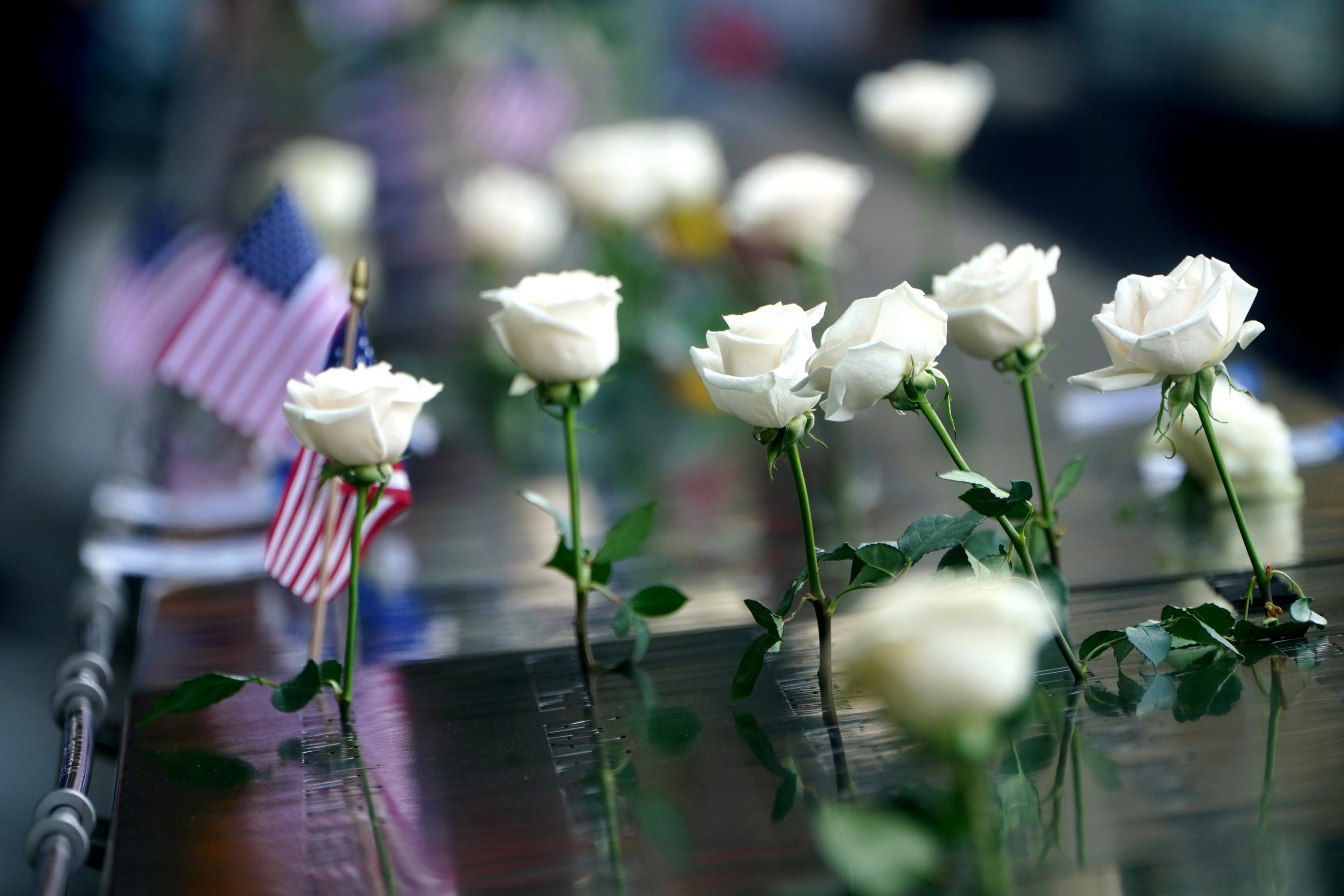 Flowers and American flags by the names of victims on the 19th anniversary of the September 11, 2001, attacks on the World Trade Center at the 911 Memorial in New York, NY, on September 11, 2020.