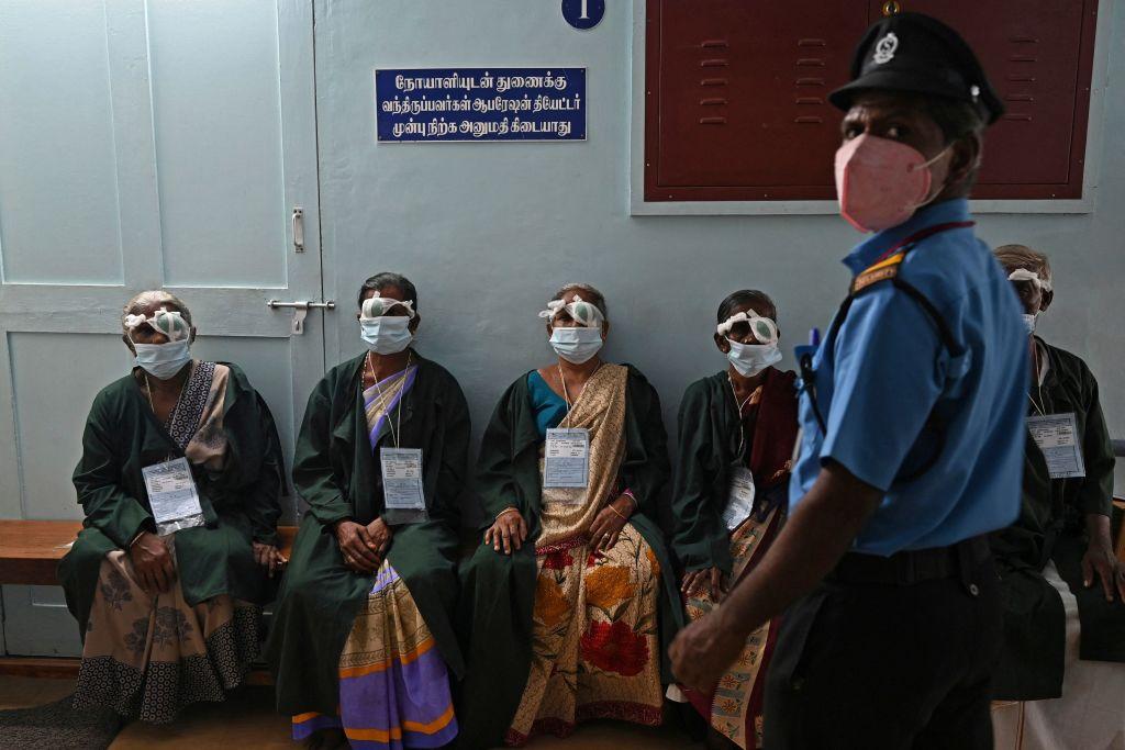 Women sit in a camp after receiving free cataract eye surgery at Aravind Eye Hospital in Madurai, India, on September 26, 2021.