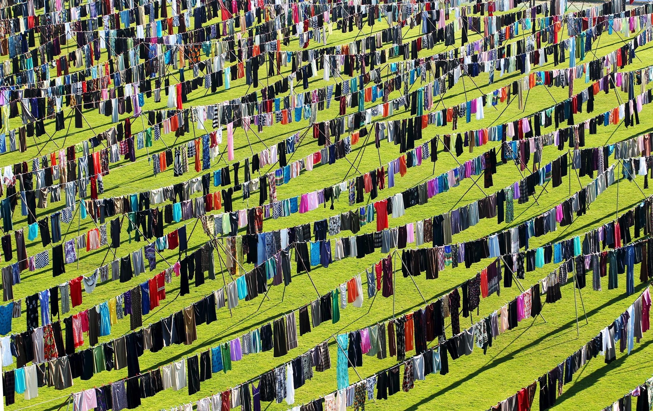 An exhibition by artist Alketa Xhafa-Mripa features thousands of dresses on clotheslines to draw attention to the tragedy of wartime sexual violence. Kosovo National Stadium, in Pristina, June 2015.