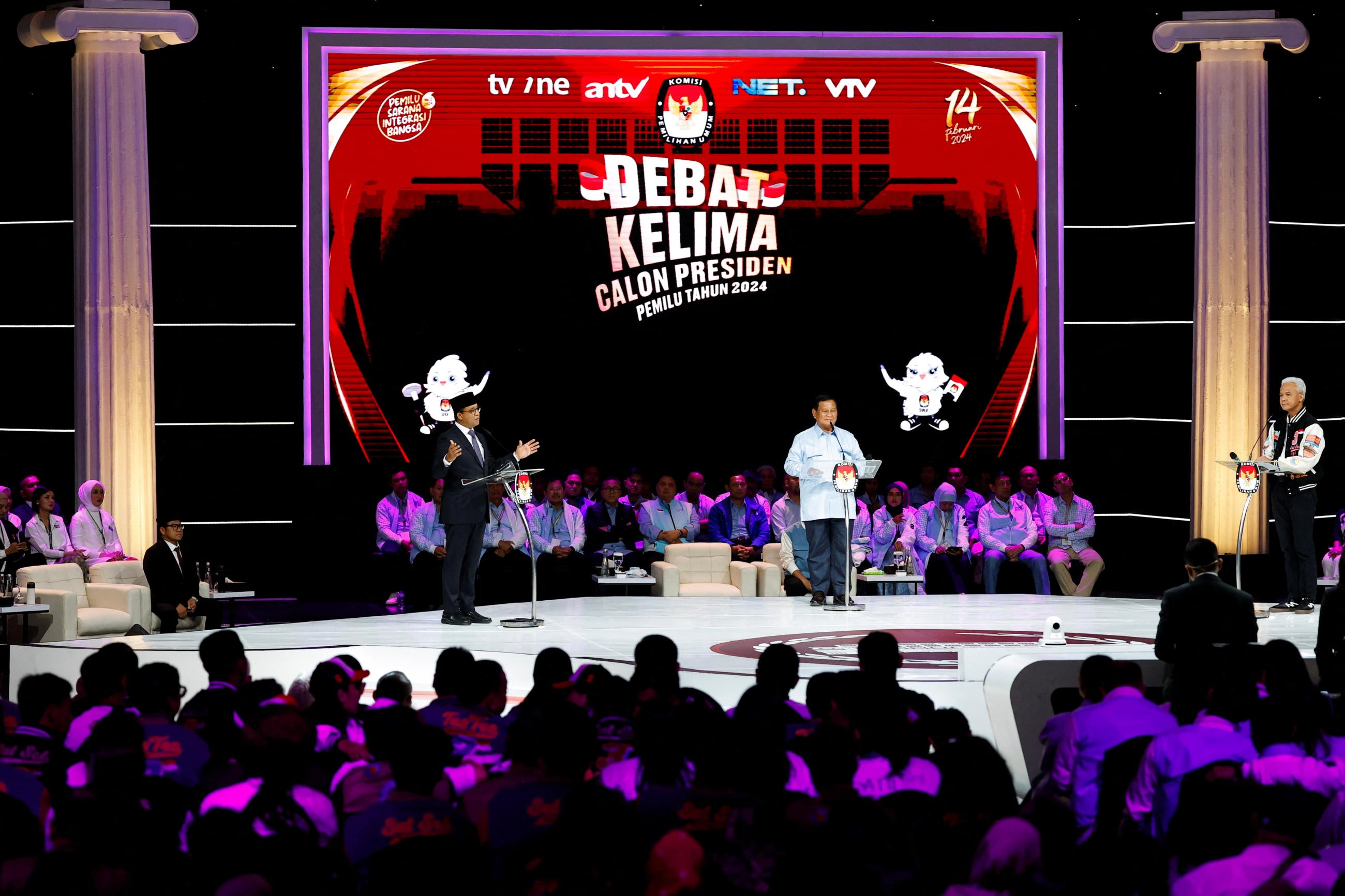 Presidential candidates stand at podiums during a televised debate ahead of the general election at the Jakarta Convention Center.
