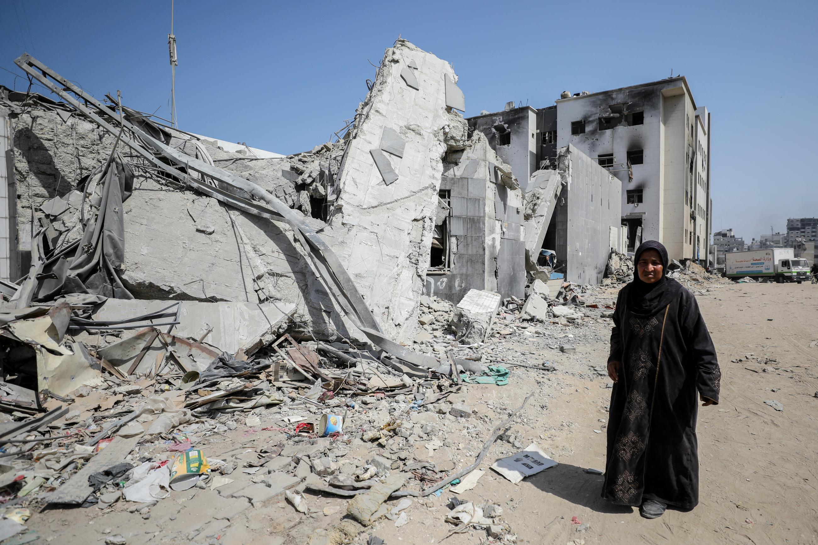A person looks on near the damaged Al Shifa Hospital after Israeli forces withdrew from the hospital and the area around it following a two-week operation.