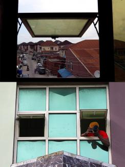 Photo is a split screen showing the photographer leaning out the window taking a picture and also a shot from inside looking out at what he was seeing. 