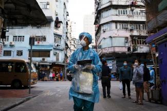 A medical worker in a protective suit walks near the residential area at Jordan, after the expand of mandatory COVID-19 testing, in Hong Kong, China, on January 19, 2021.
