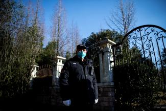 A guard stands at the gate of the Shanghai Public Health Clinical Center in China, February 17, 2020.