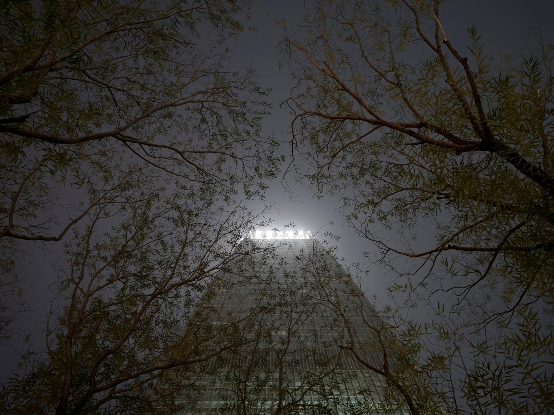 A building is pictured through trees amid heave smog on a polluted day, in Beijing, China, on December 2, 2018.