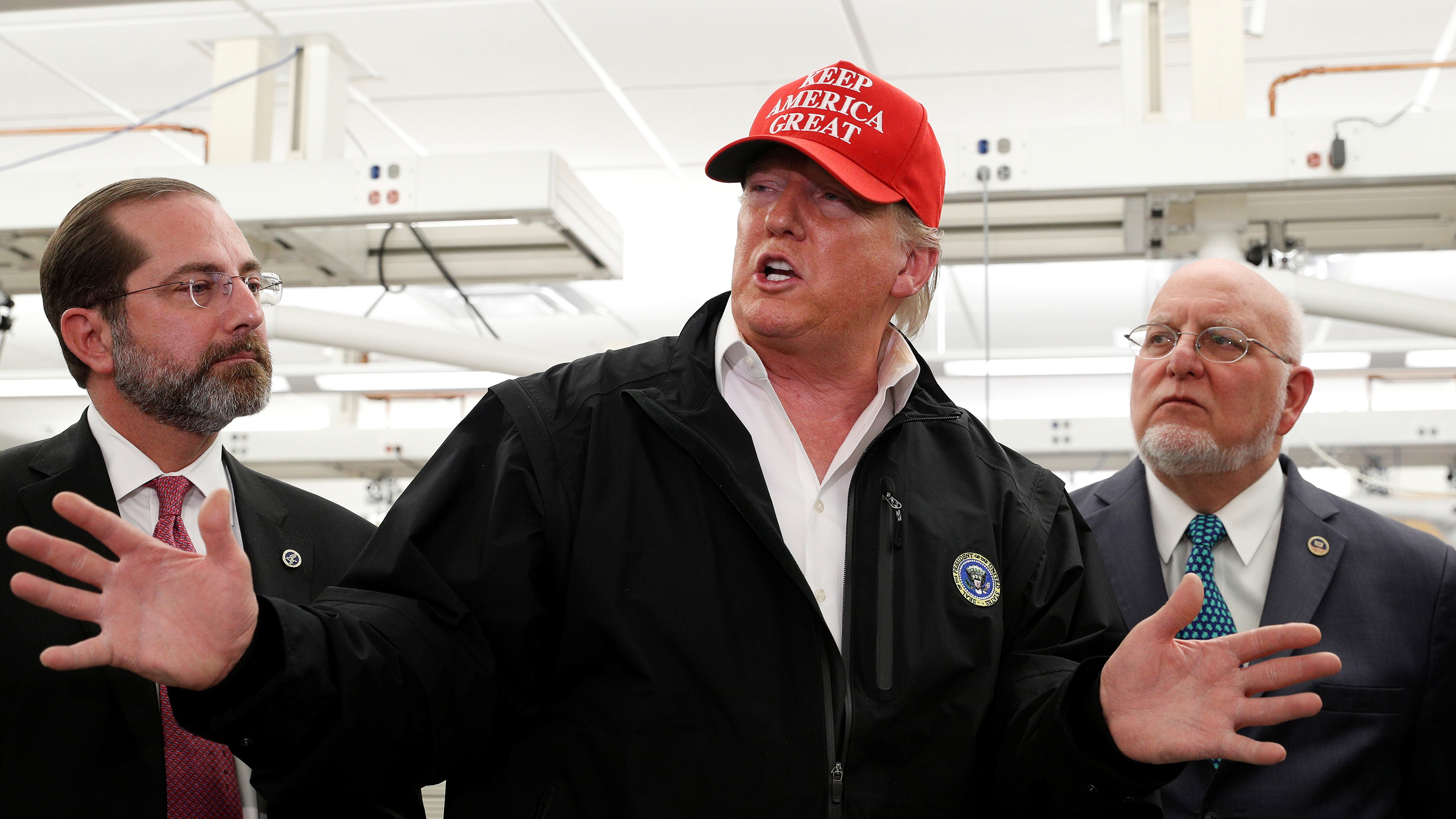 The photo shows the president with a "Make America Great Again" hat speaking and gesturing with his hands.