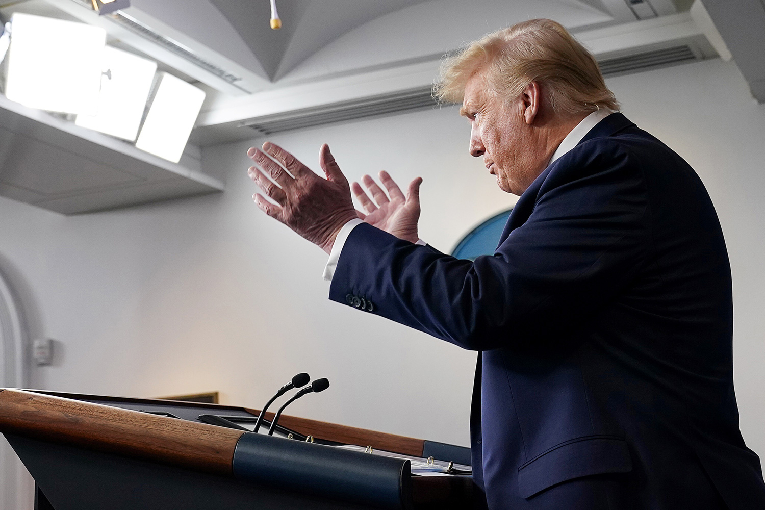 Image shows the president from the side speaking at a podium.