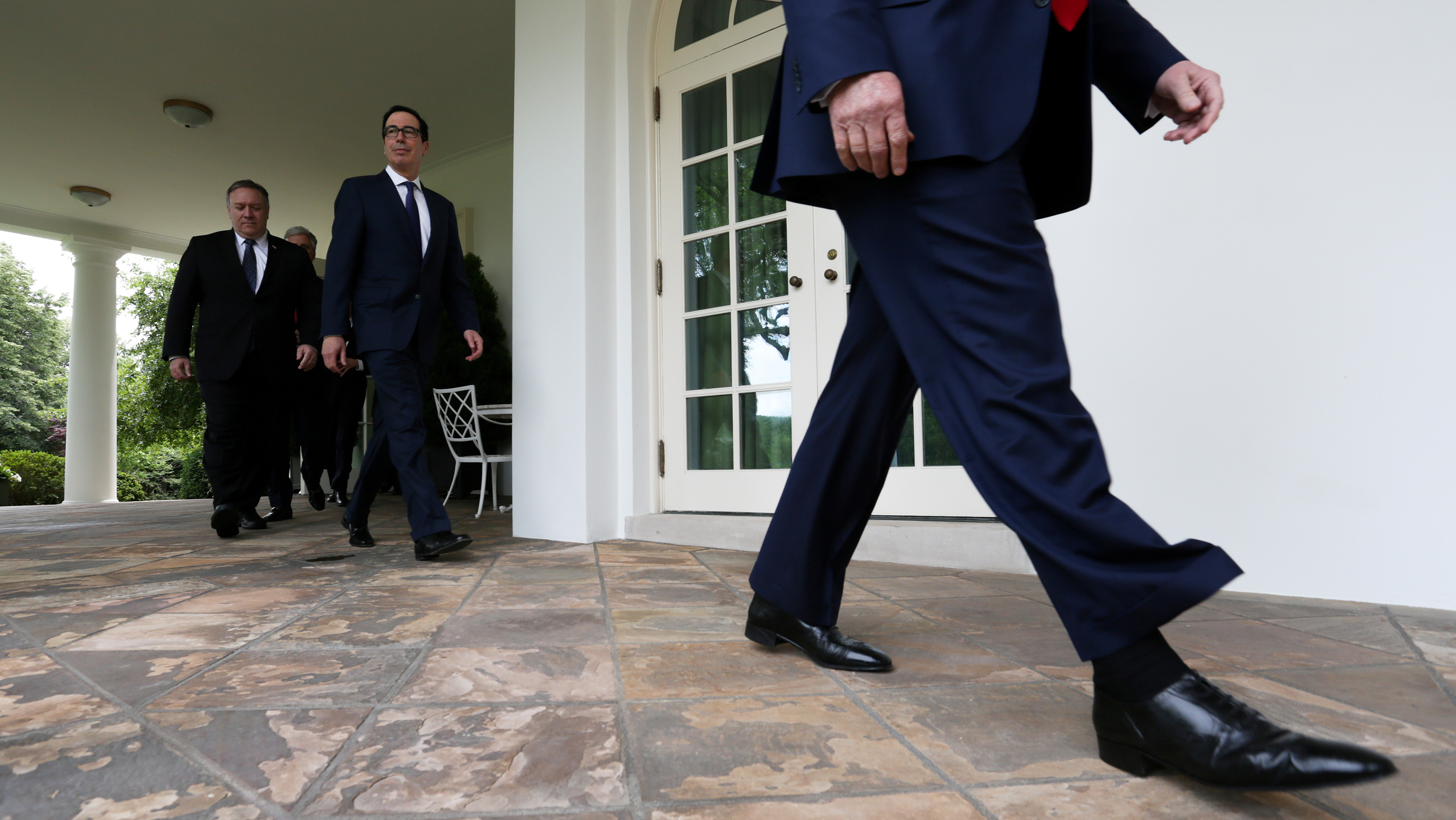 The photo shows the lower portion of the president walking past the camera with Treasury Secretary Steven Mnuchin and Secretary of State Mike Pompeo following close behind.
