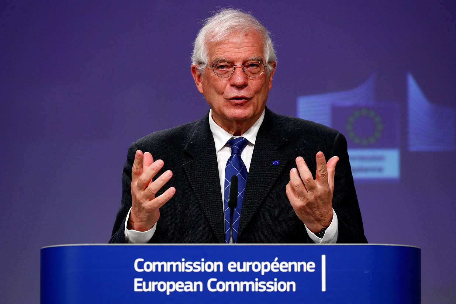 The photo shows the politician at a podium speaking and gesturing with his hands.