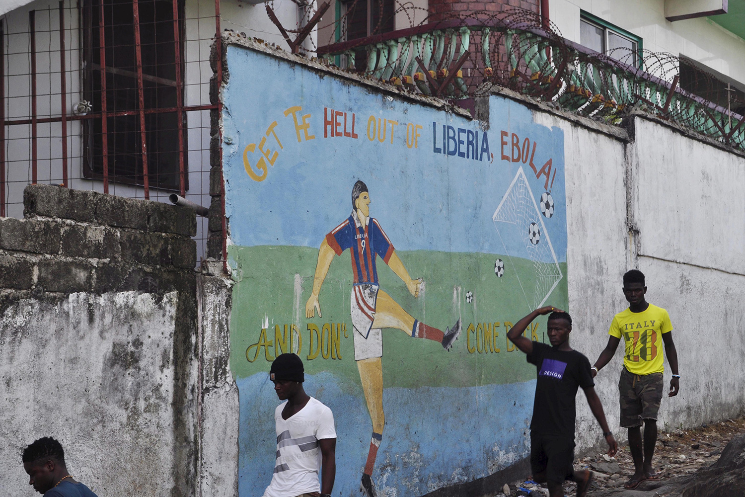 The mural reads, "Get the hell of Liberia, Ebola! And don't come back"