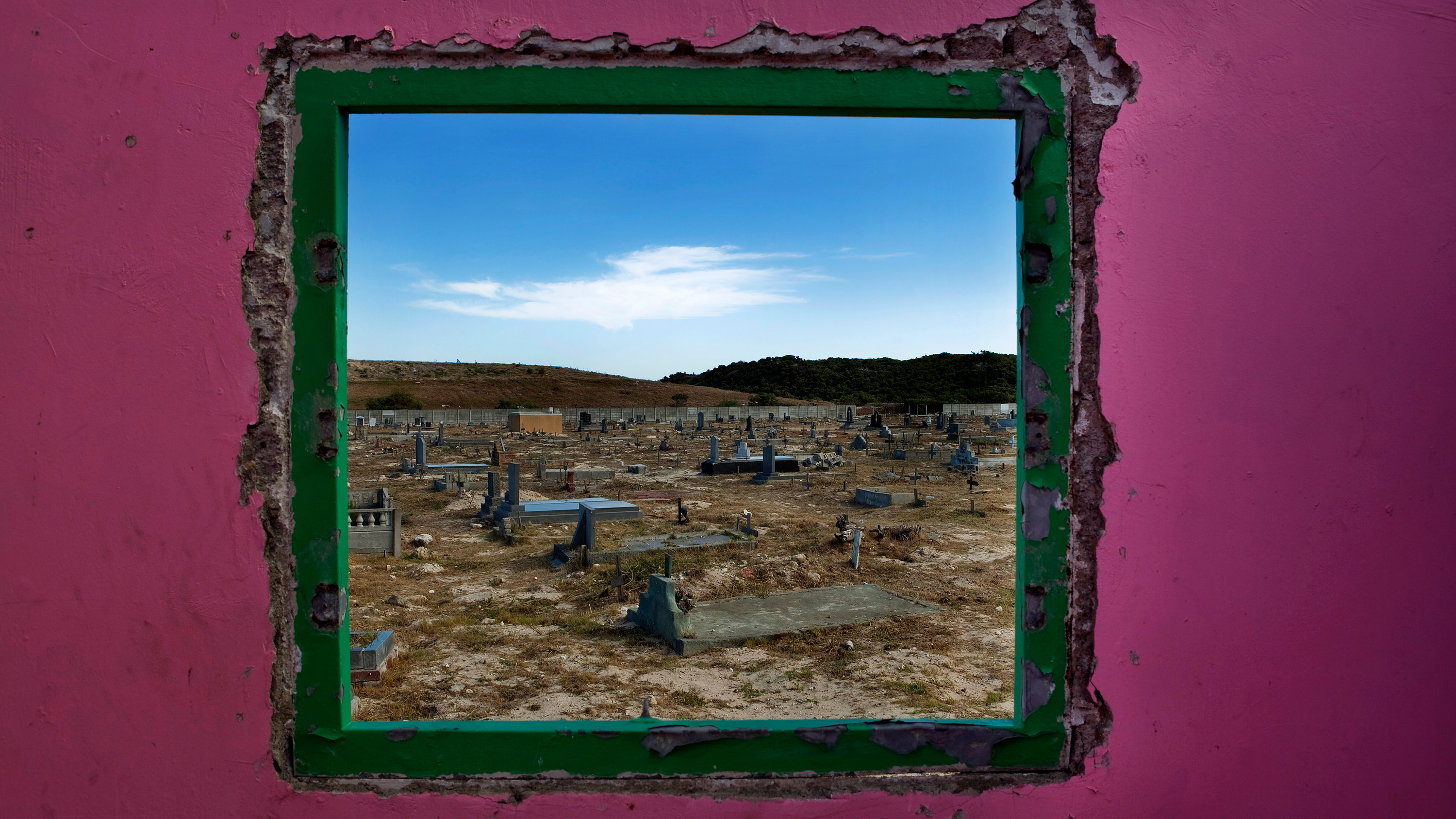 Picture shows a graveyard seen through an open window.