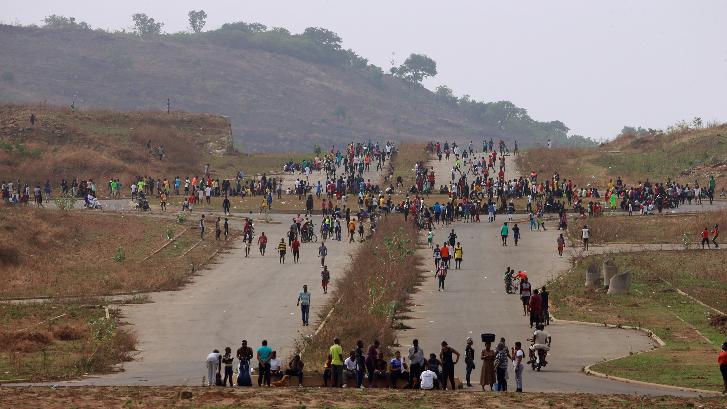 This photo shows a large crossroads from a distance that is filled with people.