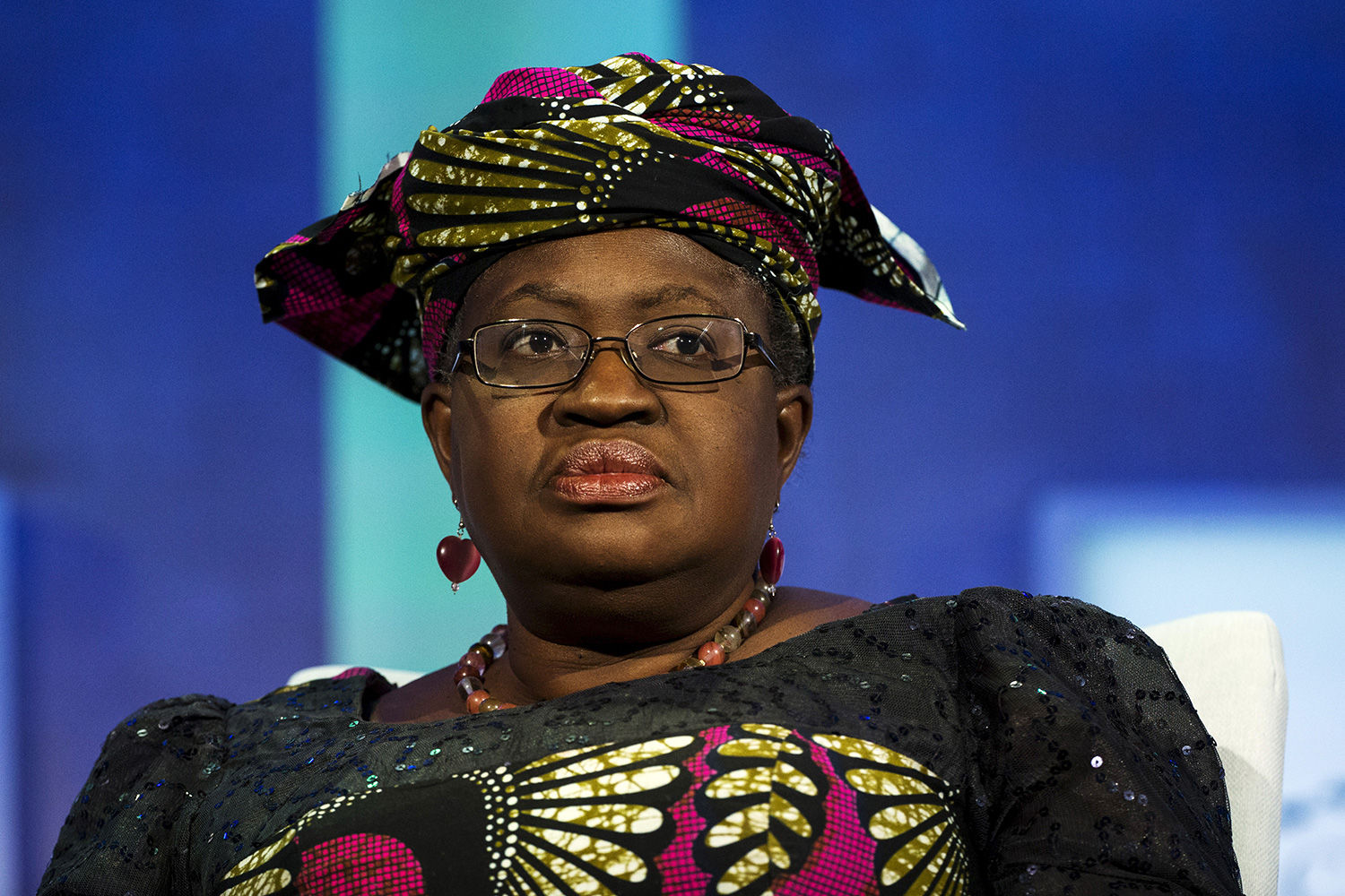 The photo is a picture of Ngozi sitting on a stage.