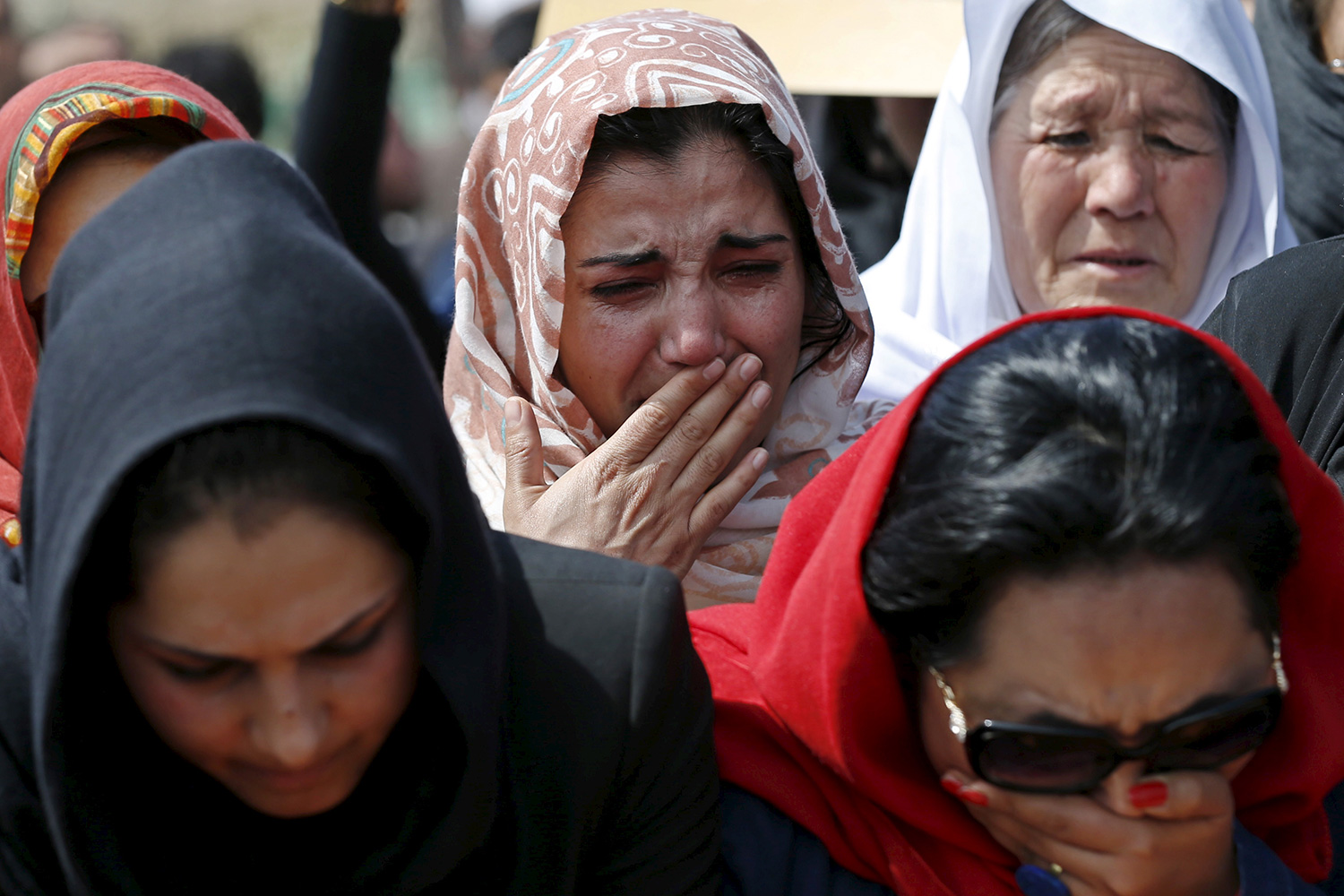 The photo shows several women weeping.