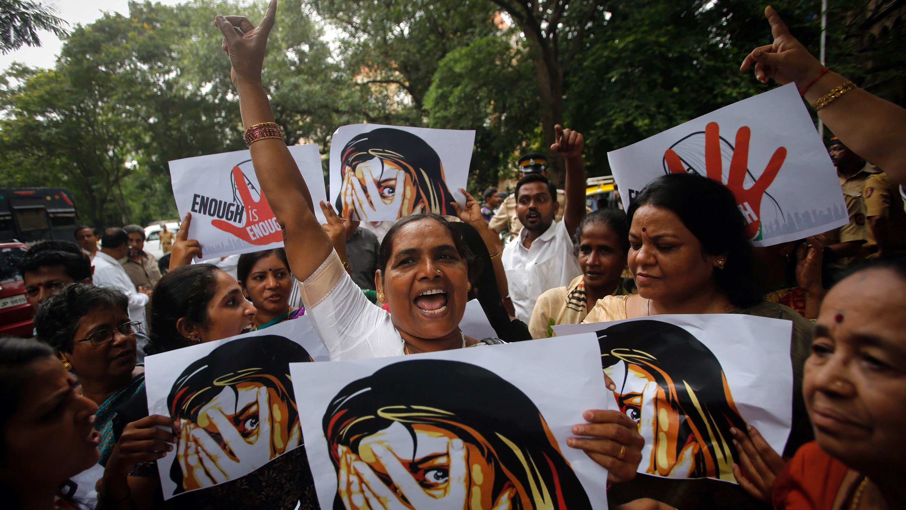 The photo shows a number of marchers with signs and fists raised in the air.