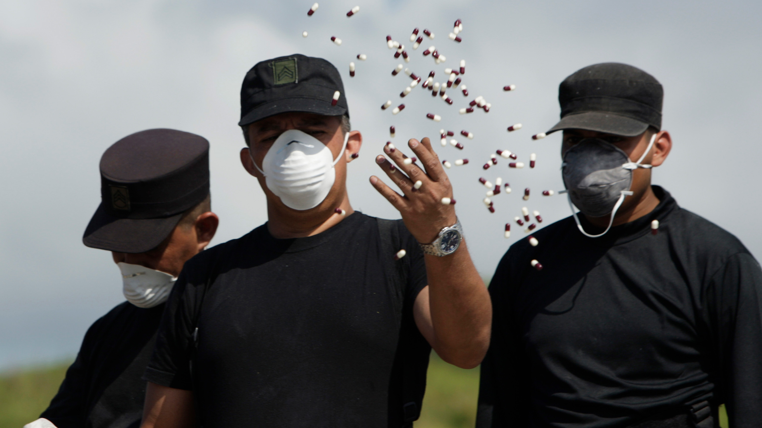 The photo shows three of Panama's anti-narcotics police, one throwing a handful of drugs seized as part of police operations around the country from November 26 to December 30, 2012.