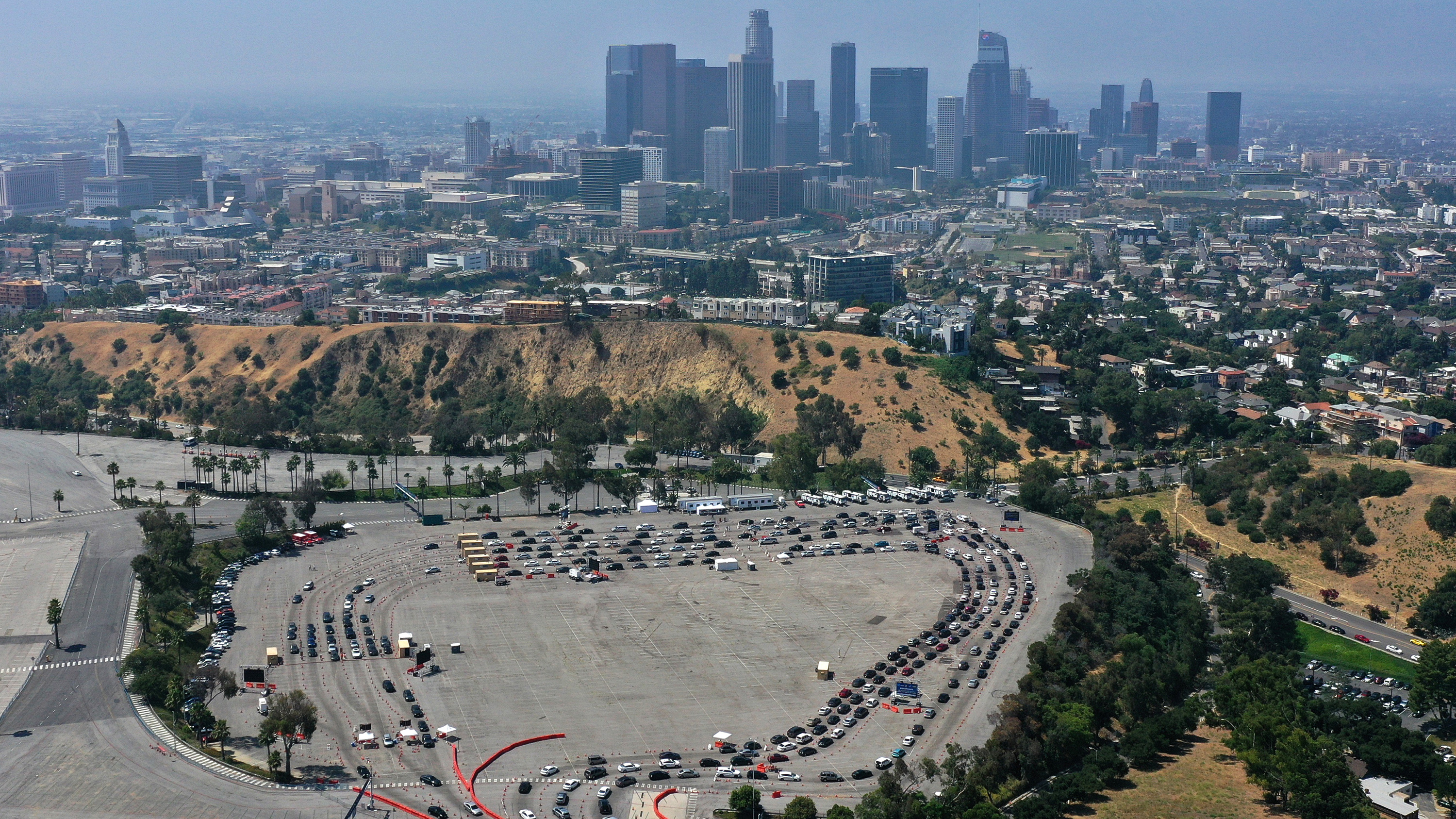 The photo is an aerial photo showing the sprawling stadium parking lot and lots of cars snaking through.
