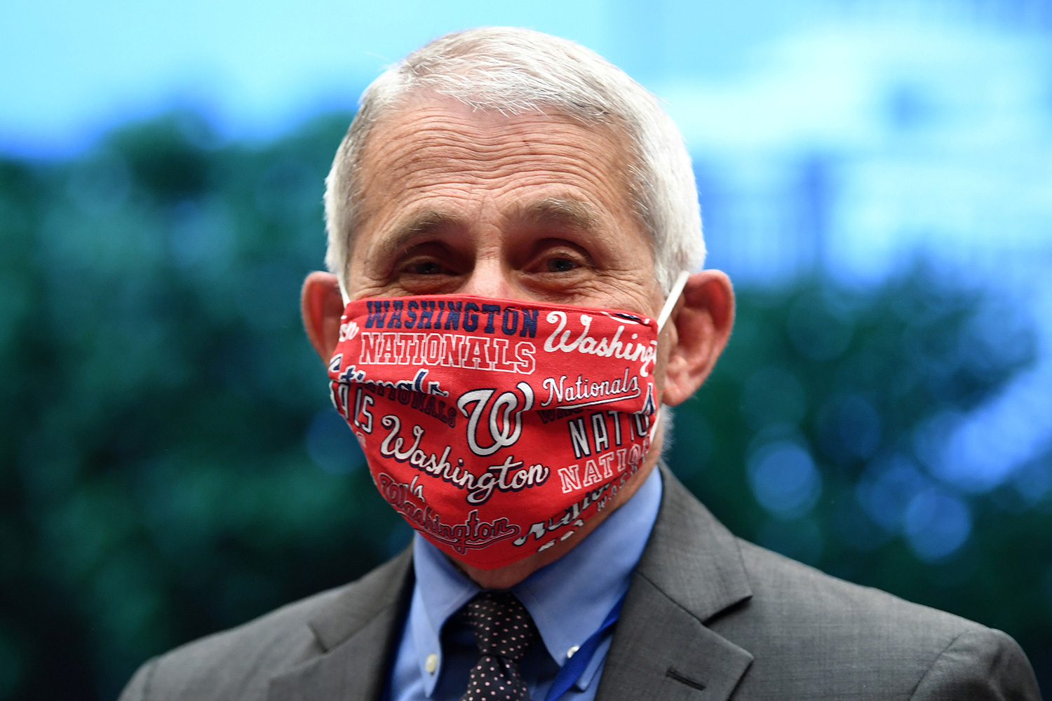 The photo shows Fauci smiling from behind a mask emblazoned with a Washington Nationals design pattern.