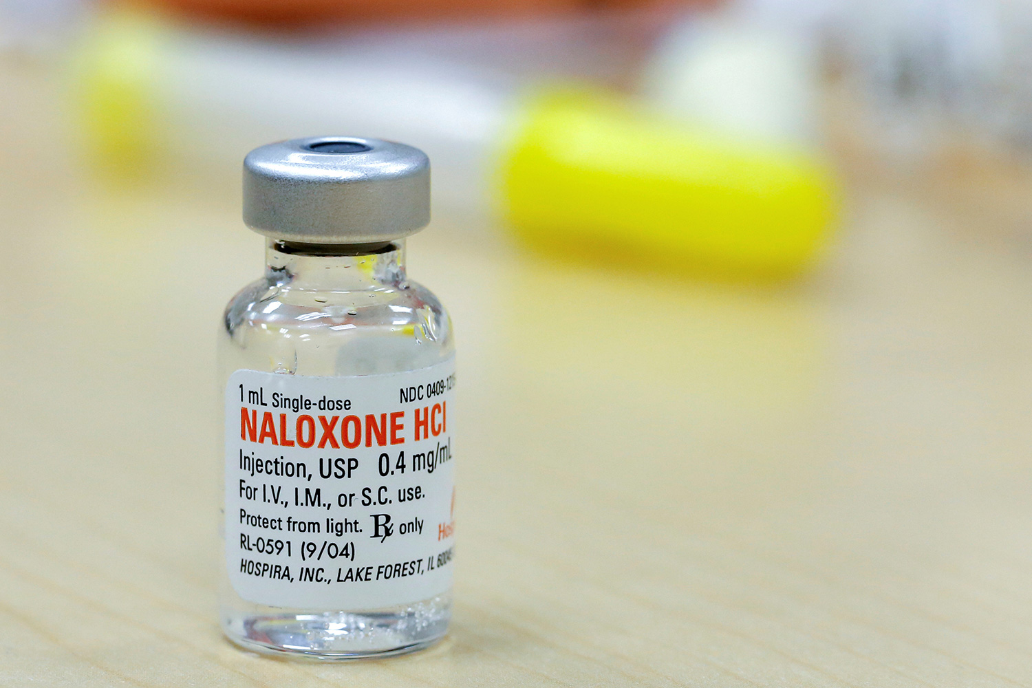 Picture shows a vial of the drug on a table.