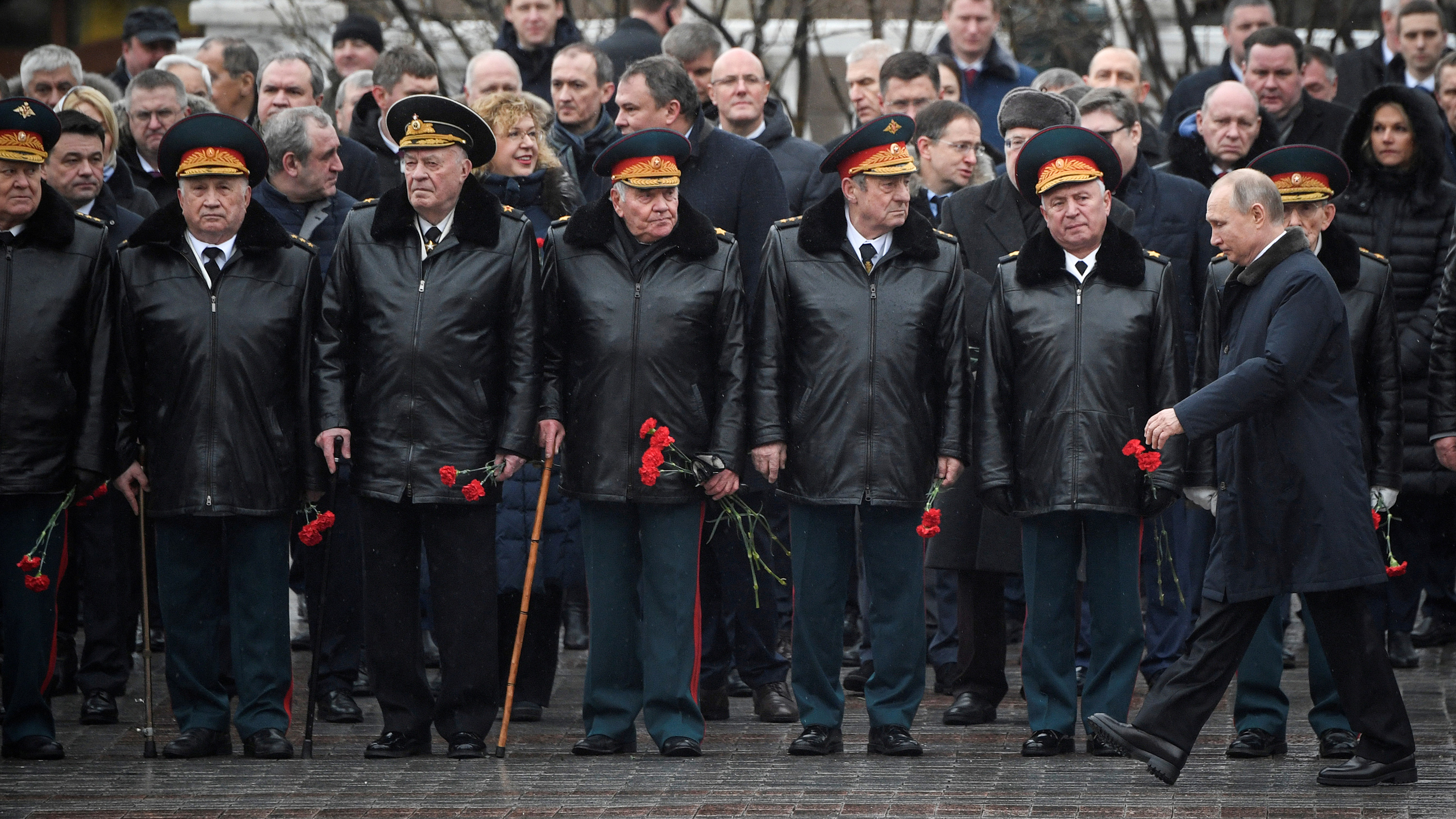 The photo shows Putin walking past a line of military top brass.