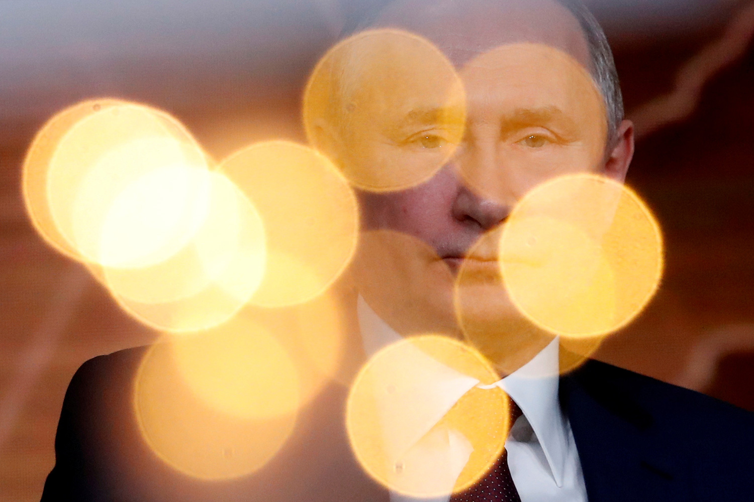 The photo shows the Russian president with lights popping off in the foreground giving a dreamy visual effect.