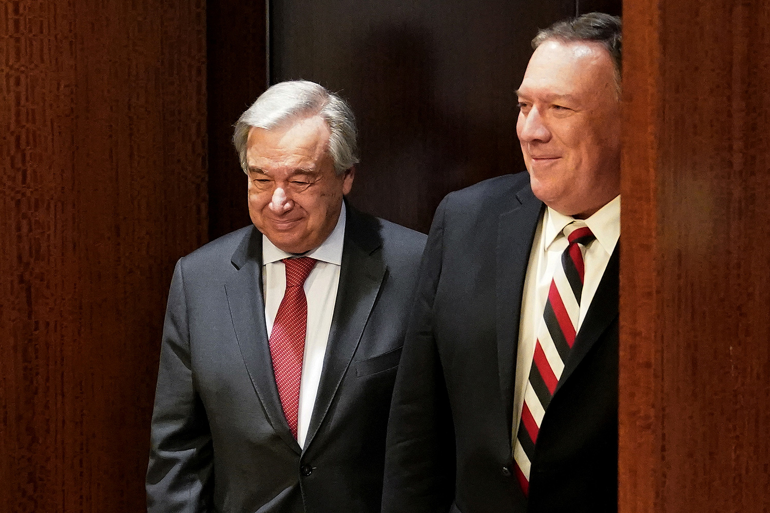 The photo shows the two diplomats walking together and smiling.