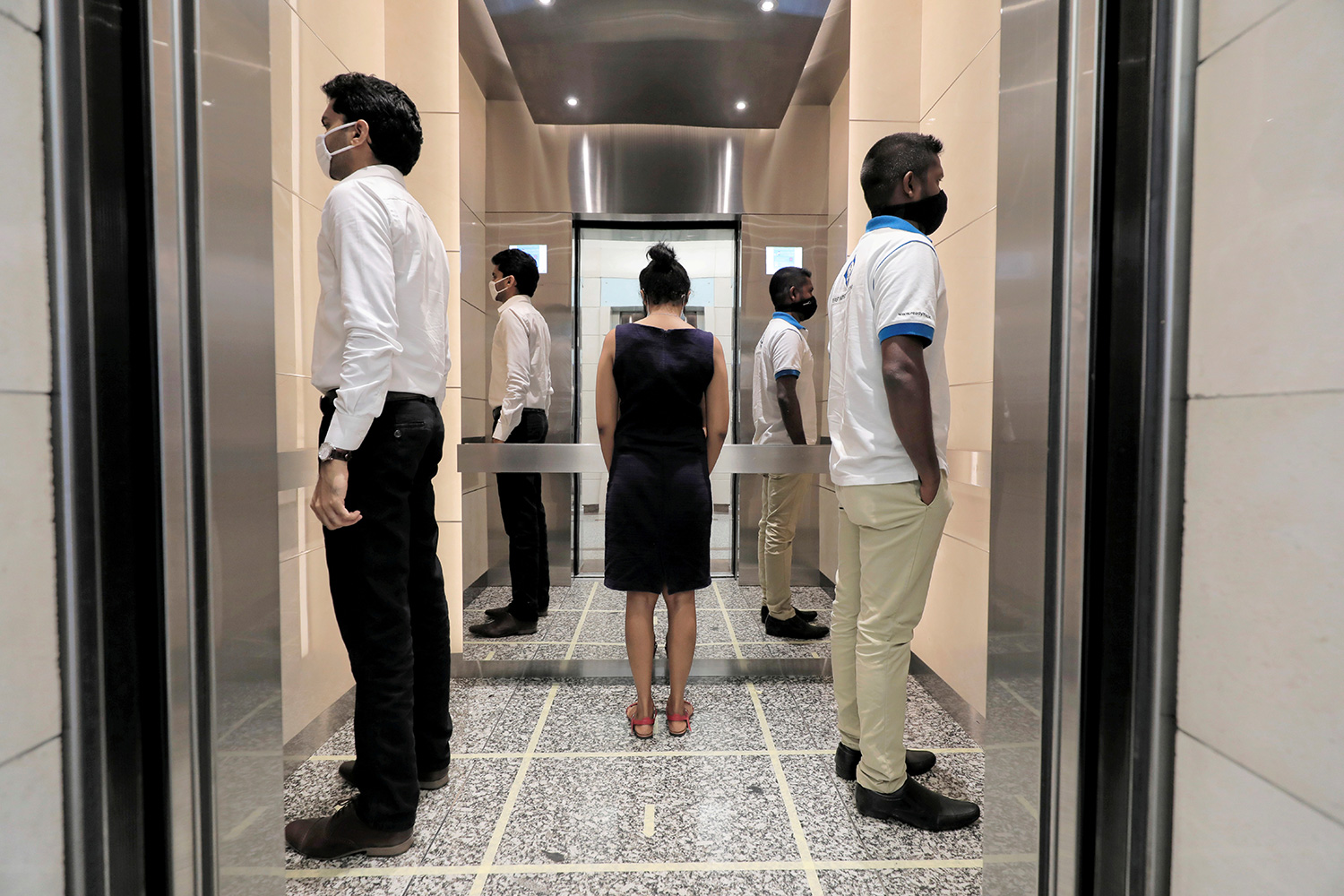 The photo shows an odd arrangement of businesspeople standing around and not facing one another.