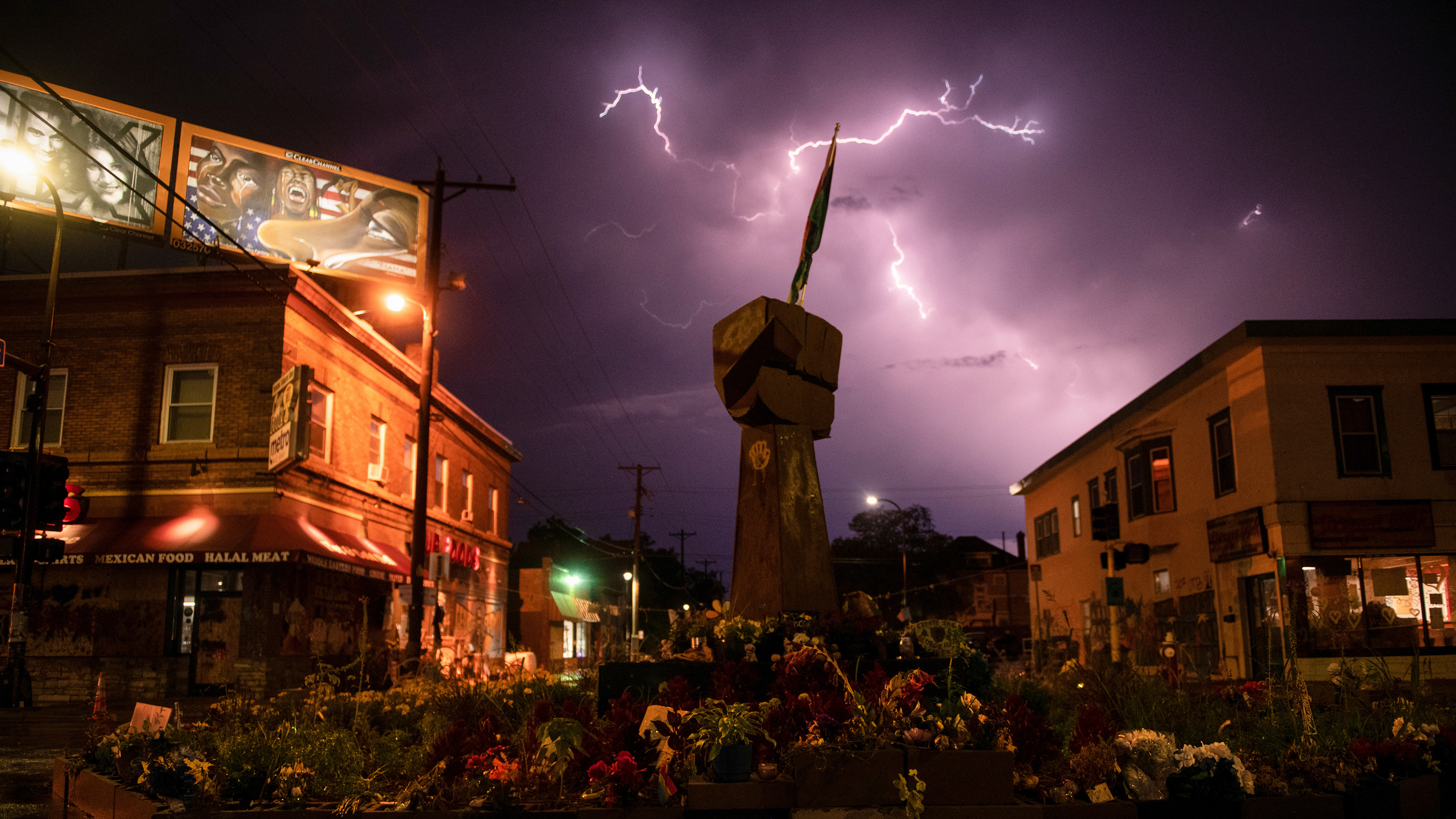 The photo shows the street where the memorial is located at night with a long-exposure photograph capturing a remarkable flash of lightning in the sky.