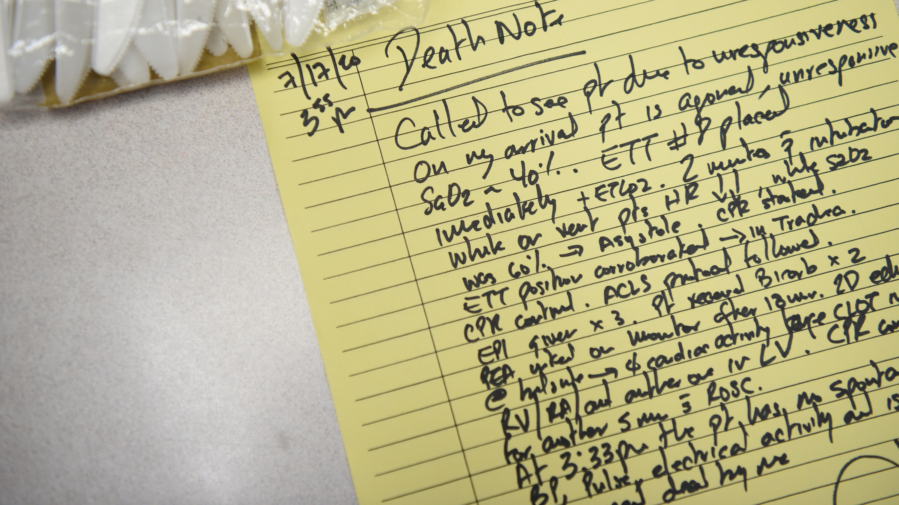 The photo shows a hand-written note with lots of detailed medical observations on a yellow pad.
