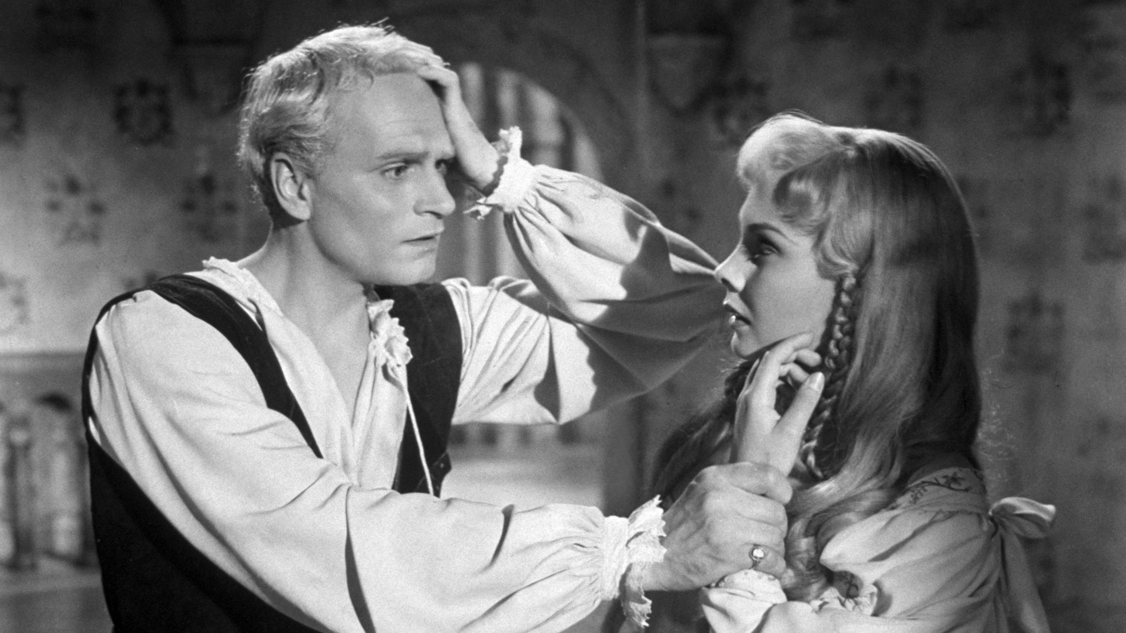 Photo shows a distraught looking Olivier and a concerned Simmons on a sound stage in this production still.